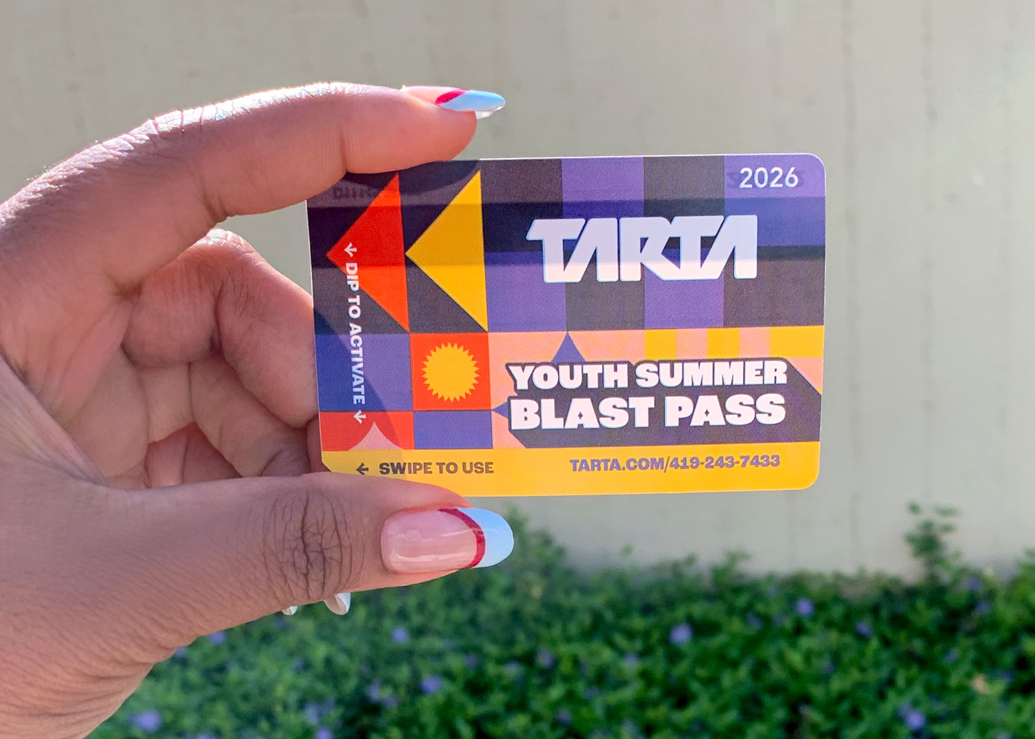 person holding 2026 TARTA Card pass outside TARTA Transit Hub