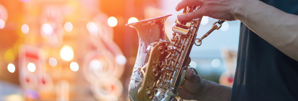 Man playing saxophone at an outdoor festival