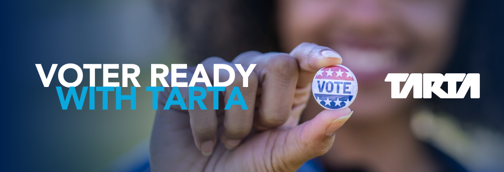 Voter Ready with TARTA; person holding vote sticker with smile on her face. TARTA logo placed next to sticker